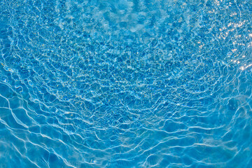 Rippled blue water surface in swimming pool