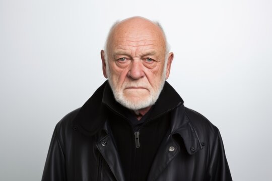 Portrait of an old man in a black leather jacket on a white background