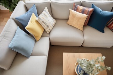 hand arranging cushions on a sectional couch