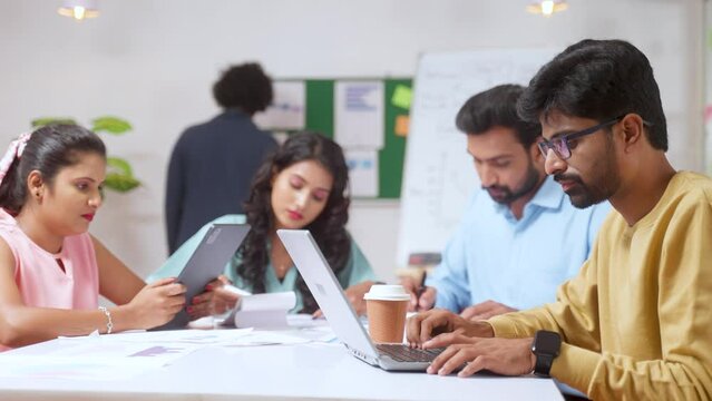 Group of Indian team of focused employees at office busy working during meeting - concept of productivity, concentration and networking.