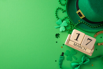 Irish delight from top view: Wooden cubes calendar marking the date, leprechaun's hat, bow tie,...