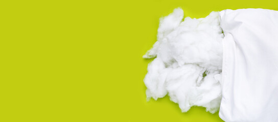 White pillow with polyester stable fiber on green background.