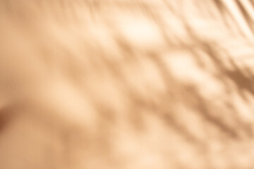Peach cream color backdrop with drapes shadows, abstract defocused photography