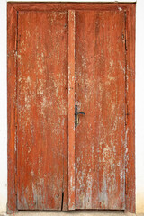 Wooden boards closed doors with brown peeling paint, abstract texture background