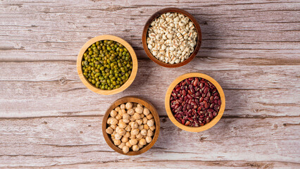 Mung beans, Red kidney beans, Chickpeas source and peeled barley in a basket wooden isolated on wood background