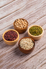 Mung beans, Red kidney beans, Chickpeas source and peeled barley in a basket wooden isolated on wood background