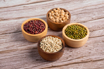 Mung beans, Red kidney beans, Chickpeas source and peeled barley in a basket wooden isolated on wood background