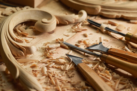 Artisan carving decorative wooden plate. Woodworker carving a wood