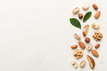 Composition of nuts , flat lay - mix hazelnuts, cashews, almonds on table background. healthy...
