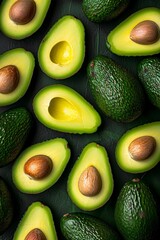 variety of sliced and whole green avocados arranged on a dark green surface.