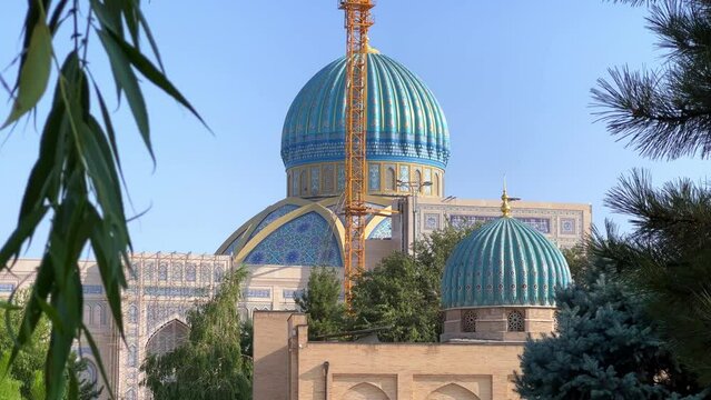 Khast Imam Square with an architectural complex combining ancient religious buildings with modern ones. Lawns, flower beds, shrubs. Cathedral Mosque in Tashkent. 4K