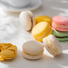 Sweet and colourful french macaroons or macaron on a light background.