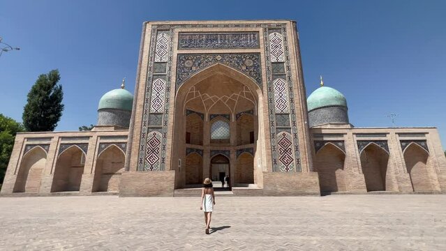 4K Gimbal Shot: Young Woman Approaching Hazrati Imam complex, Tashkent, Uzbekistan; Showcasing Islamic Architecture, Mosaic Tilework, and Central Asian Heritage.