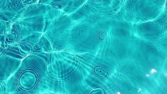 Vibrant blue pool water with light patterns depicting leisure or summer concepts