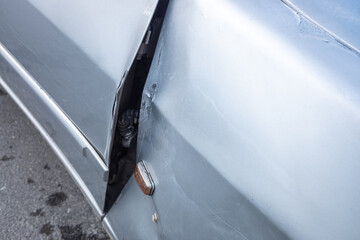 detail of a car door deformed by an impact