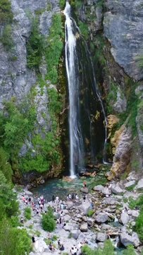 Aerial drone view of the waterfall in Theth national park, Albania. Walking away towards the waterfall