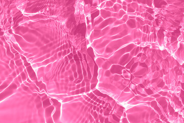 Pink water splashes on the surface ripple blur. Defocus blurred transparent pink colored clear calm...