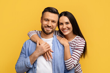 Happy Spouses. Portrait of cheerful european couple hugging and smiling at camera