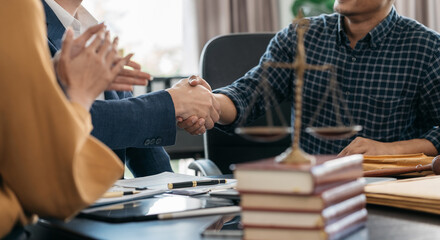 Obraz na płótnie Canvas Lawyer shaking hands with client after discussing final contract agreement.