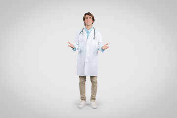 Cheerful doctor with open hands in welcoming gesture