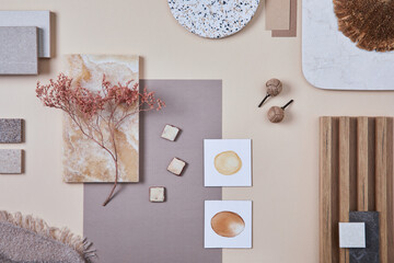 Flat lay of stylish architect moodboard composition with beige samples of textile, paint, wooden lamella panels and tiles. Top view. Copy space. Template.