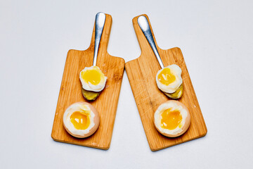soft boiled eggs on a stand ready to be eaten.