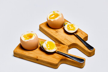 soft boiled eggs on a stand ready to be eaten.