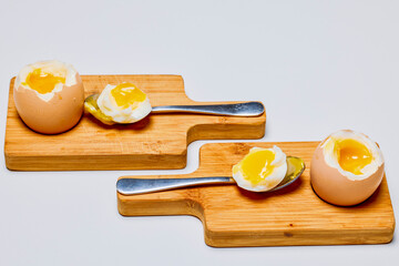 soft boiled eggs on a stand ready to be eaten.