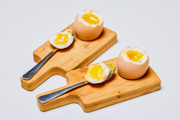 soft boiled eggs on a stand ready to be eaten.