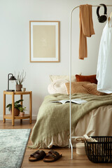 Stylish composition of cozy bedroom with mock up, beige bedding, and wooden coffee table. Mock up...