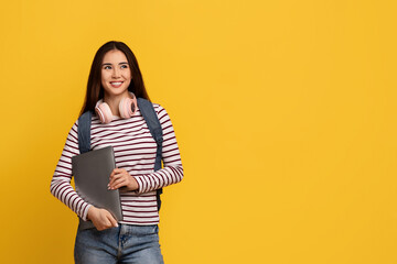 Happy young asian lady student holding laptop