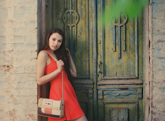 Сute girl near the old wooden door