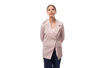 young attractive european brunette woman dressed in a stylish beige jacket on a white background with copy space