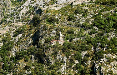 Observation tower and wall of the fortress of the city of Kotor on the steep slopes of the mountains