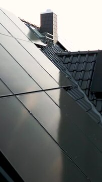 Vertical Video of a Close Flight Over a Sustainable Family House with Solar Panels