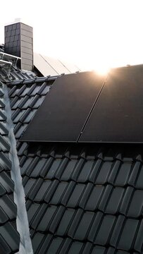 Vertical Video of Solar Panels on the Roof of a Sustainable Single-family House at Sunrise
