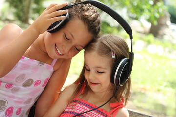 Sisters listen to the music together