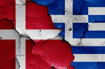 flags of Denmark and Greece painted on cracked wall