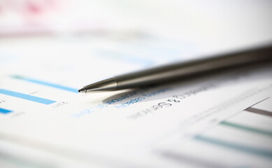 Financial statistics documents ball pen infographics at office table closeup. Internal Revenue...