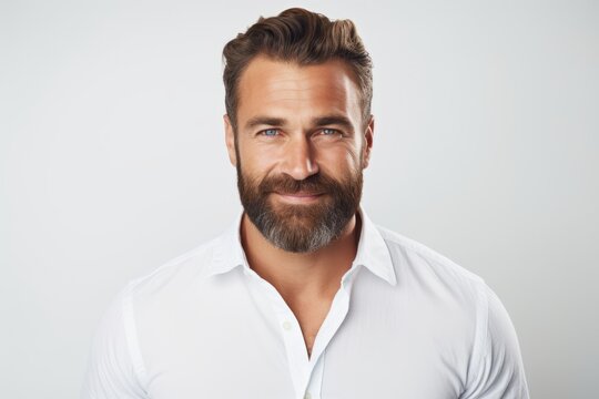 Portrait of handsome bearded man in white shirt. Isolated on grey background.
