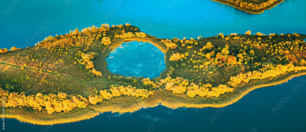 Wall mural amazing scenic aerial bright sunbeams view green meadow and river landscape in sunny spring day. top