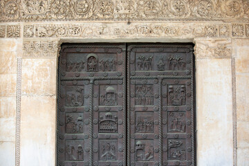 Facade with decorative door of romanesque Pisa Cathedral, Duomo Square of Pisa, Pisa, Italy
