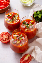 Spanish tomato gazpacho cold soup styled and decorated in glasses