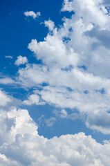 Fluffy white cumulus clouds in a blue sky on a beautiful day, natural soft background with copy space for text