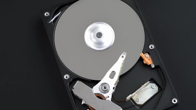 Hard disk drive inside with rotating platter and riding arm