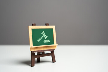 Chalk board and judge's hammer. The supremacy of international law. Win lawsuit. International...
