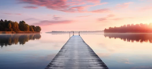 Muurstickers Tranquil morning scene on a lakes jetty at sunrise, calm water, and soft morning light © Postproduction