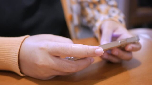 Closer shot of an individual browsing the internet and social media using her mobile smart phone.