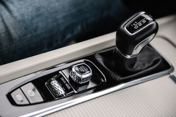 Modern gearbox car. Electronic handbrake button. Gear shift stick into P position, (parking) symbol...
