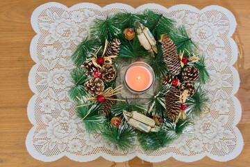 Christmas and new year season, candle between fir sprig, candle, cones and red mushroom heads